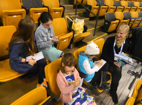 Mimi McKinnis, the communications coordinator for US Figure Skating, answers questions from Cunniff Kids News reporters while in the TD Garden stands on Monday, March 2018 -- the first day of the 2016 World Figure Skating Championships.