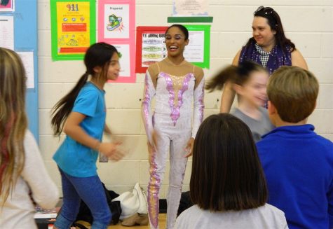 Shenea Booth (center), hand balancer from Cirque Dreams Holidaze, visited Lowell Elementary School in Watertown, Mass., on Friday, Nov. 18, 2016. 