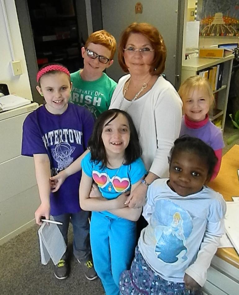 Terri Caporiccio (center) is surrounded by reporters from the Cunniff Kids News. She will be competing in the Dancing with the Stars fund-raiser for the Watertown Education Foundation on Friday, March 14.