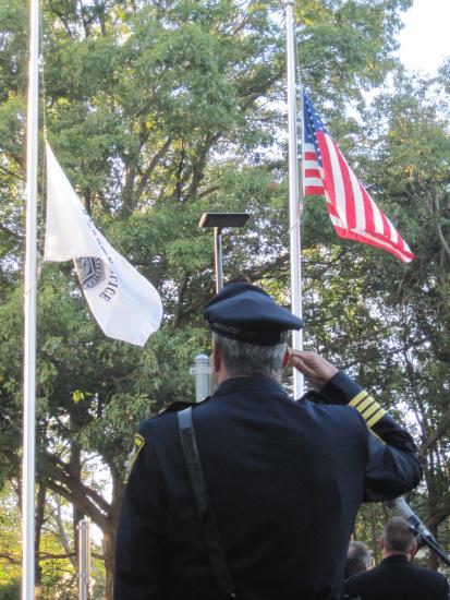 Chief Edward Deveau stands at attention as the honor guard raises the colors to begin the festivities at the ceremonial opening of Watertowns new police station on Oct. 7, 2010.