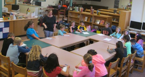 Jaclyn Meyer (standing left), the new art teacher at Cunniff Elementary in Watertown, Mass., talks with the staff of the Cunniff Kids News during an interview in the newsroom Oct. 6, 2015.