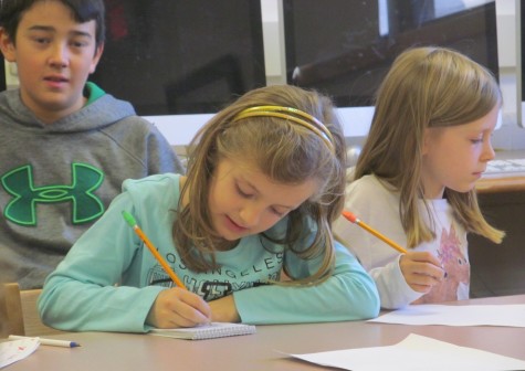 Cunniff Kids News reporters take notes during an interview with new Cunniff Elementary art teacher Jaclyn Meyer on Oct. 6, 2015.