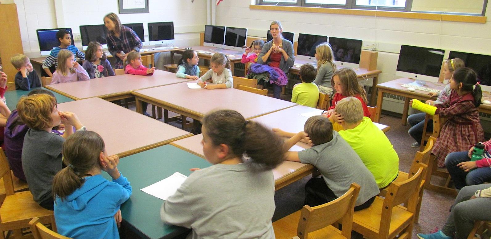 Lee Haley (back row center, in grey sweater), a parent volunteer with the Cunniff School PTO, talks with Cunniff Kids News reporters about the annual Halloween Party to be held Friday, Oct. 30, 2015.
