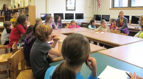 Lee Haley (second from right), a parent volunteer with the Cunniff School PTO, talks with Cunniff Kids News reporters about the annual Halloween Party to be held Friday, Oct. 30, 2015.