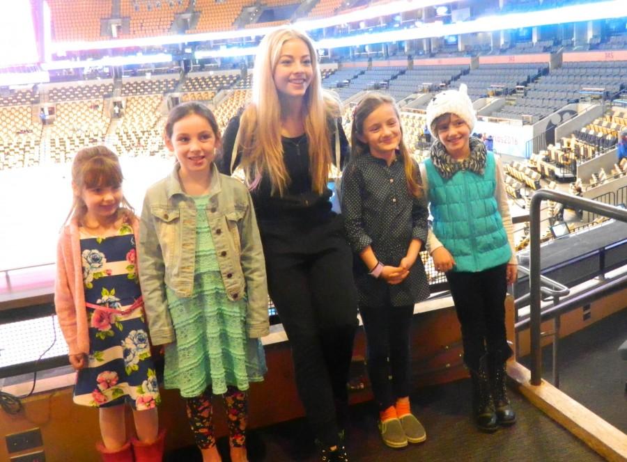 Gracie Gold (center) poses with reporters from the Cunniff Kids News at TD Garden on Monday, March 28 -- the first day of the 2016 World Figure Skating Championships.
