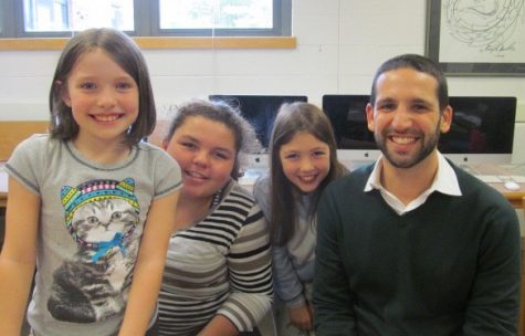 Adam Silverberg (right), the world language coordinator for the Watertown public schools, poses with reporters after a recent interview in the newsroom of the Cunniff Kids News.