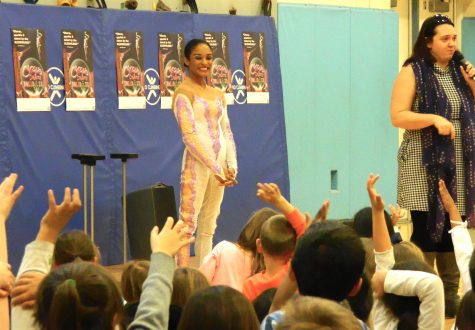 Shenea Booth (center), hand balancer from Cirque Dreams Holidaze, answered questions from students during her visit to Lowell Elementary School in Watertown, Mass., on Friday, Nov. 18, 2016. 