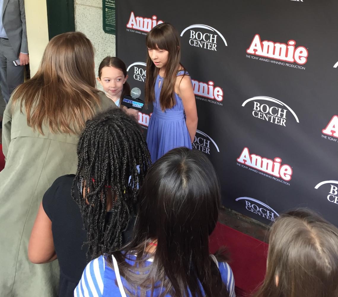 Sisters Katie (left) and Amanda Wylie from the cast of Annie talk with reporters on the red carpet outside the Boch Center/Wang Theatre before their show May 10, 2017.
