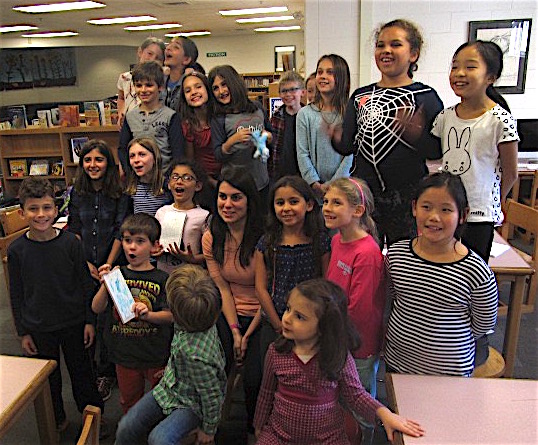 Maruchi (Maria) Koehler, the new Spanish teacher at Cunniff Elementary School in Watertown, Mass., poses with reporters from the Cunniff Kids News after a recent interview.