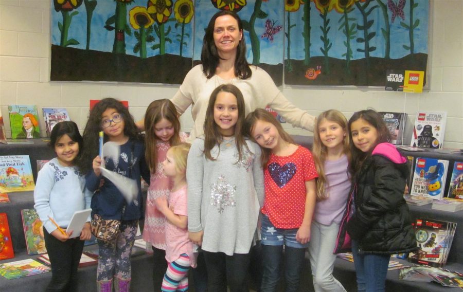 Bitt Days of the Cunniff Elementary School PTO stands behind reporters from the Cunniff Kids News after an interview Tuesday, Dec. 5, 2017.