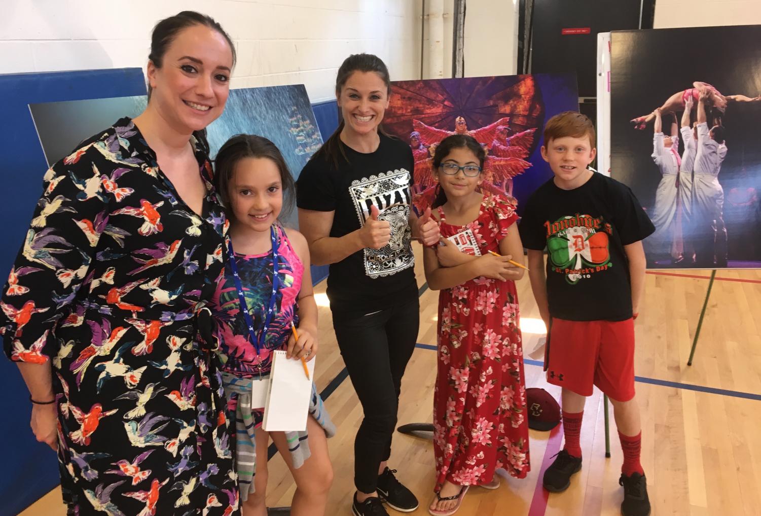Cirque du Soleil artistic director Gracie Valdez (left) and aerialist Kelly McDonald (center) poses with reporters from the Cunniff Kids News after their visit to Cunniff Elementary School in Watertown, Mass., on June 11. Their new show Luzia will be in Boston from June 27 to Aug. 12, 2018, at Suffolk Downs.