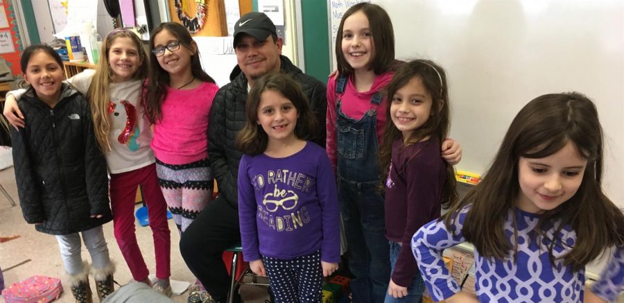 Milton Contreras (center, wearing hat) poses with reporters from the Cunniff Kids News after a visit to the newsroom Wednesday, Jan. 30, 2019.